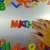 Hand Writes Math with Fridge Magnets