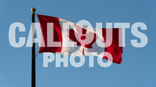 Canadian flag agains blue sky